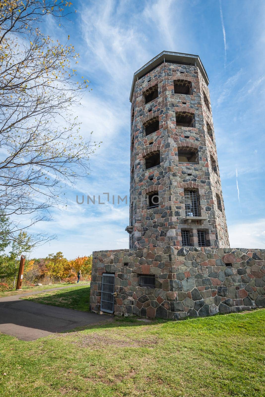 Stone tower in middle of a public park during autumn