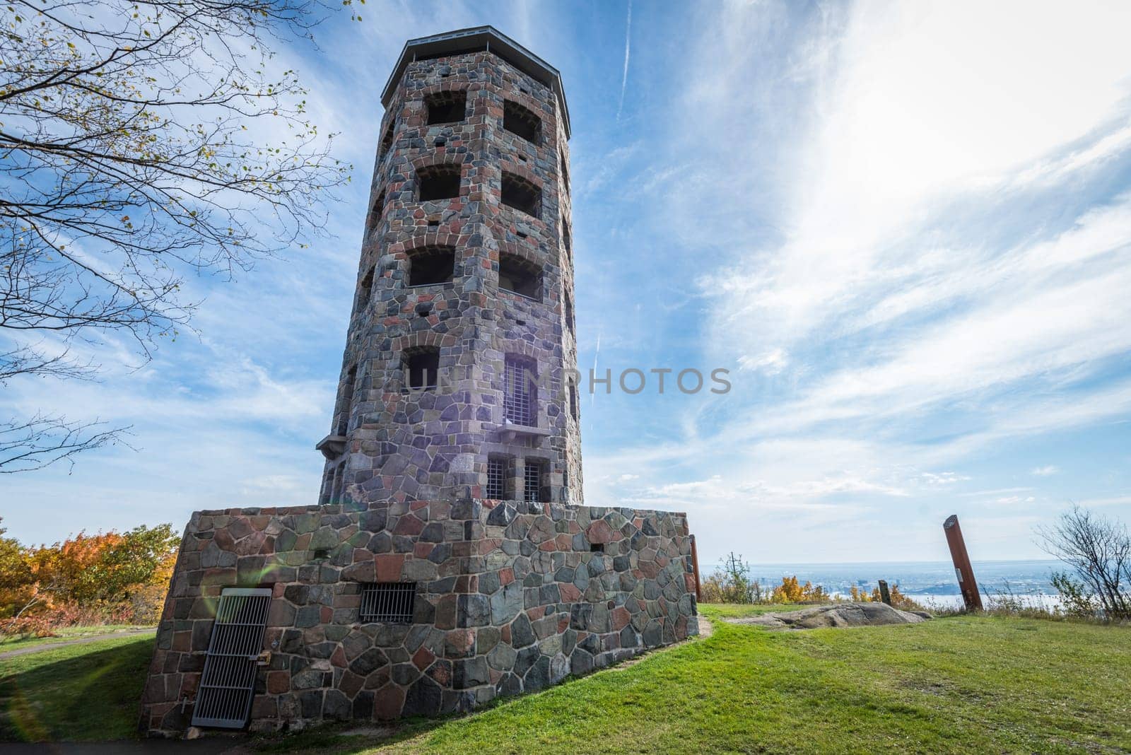 Stone tower in middle of a public park during autumn
