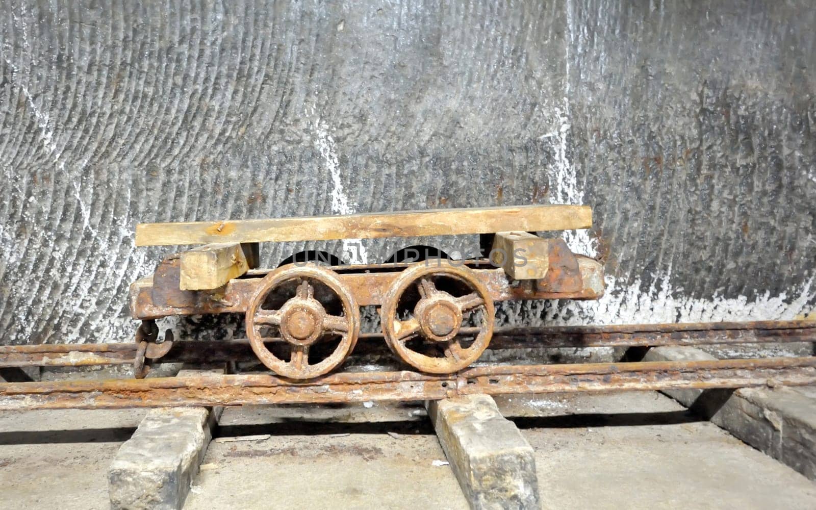 old  wagon inside of salt mine on rail