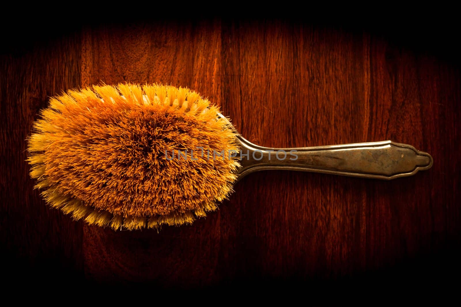 Vintage hairbrush on solid dark wood