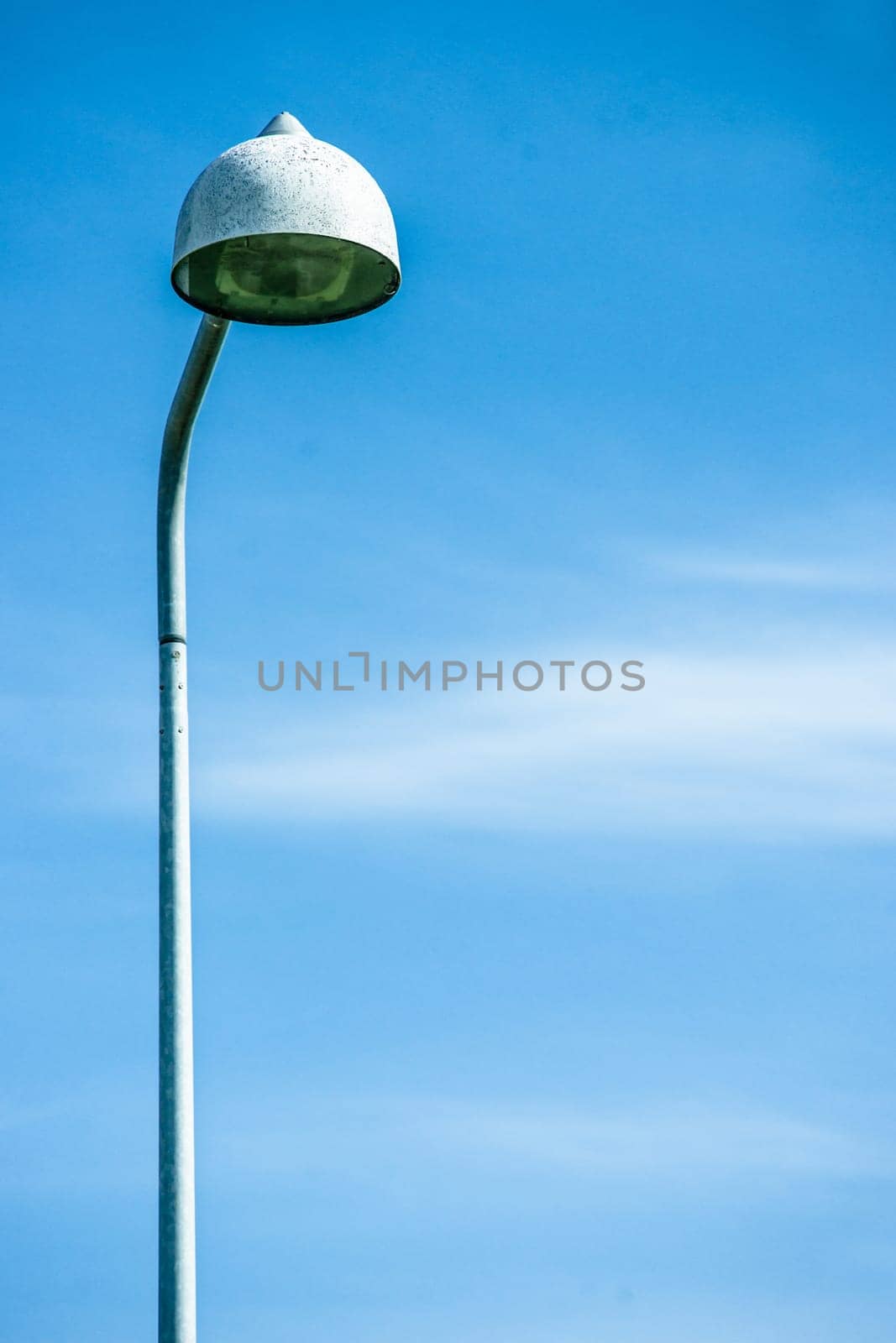 Tall streetlight lamp isolated on blue