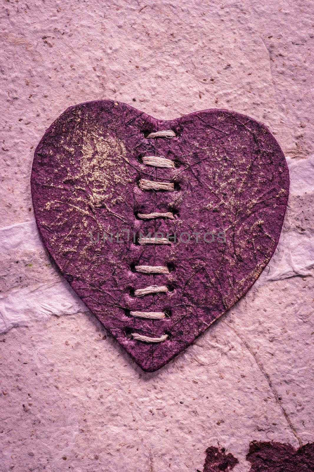Romantic purple heart on a rough surface