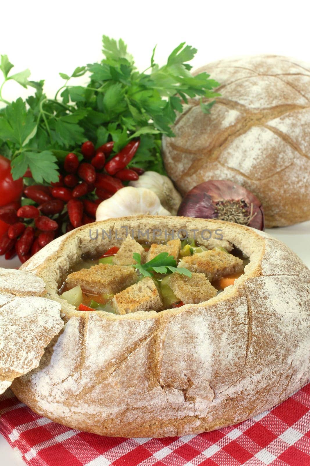 a farmer's bread filled with a colorful bread soup