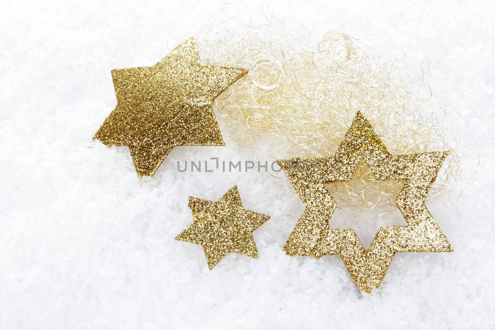 Christmas,golden poinsettias on artificial snow
