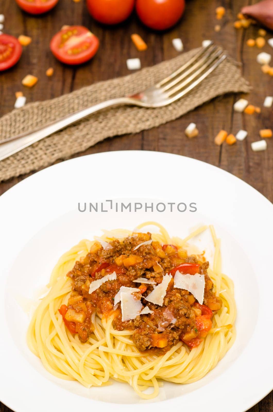 Plate of spaghetti Bolognese and Parmesan cheese