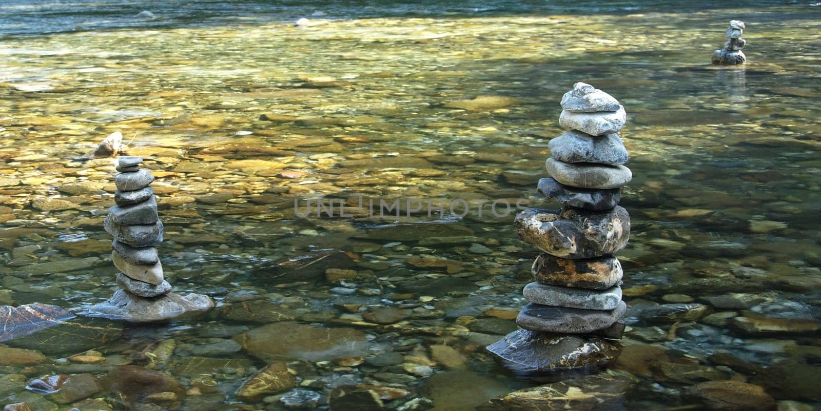 Three stone men in a river