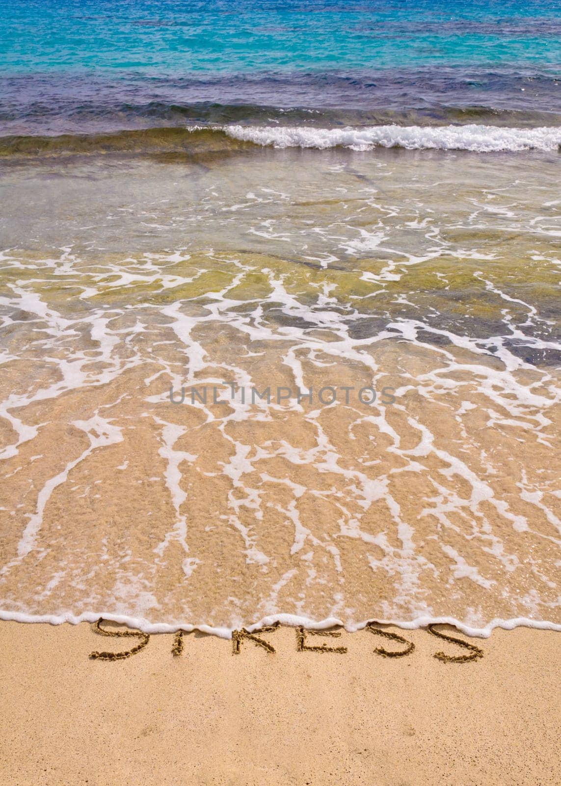 Words Stress written on sand, washed away by waves, relax concept