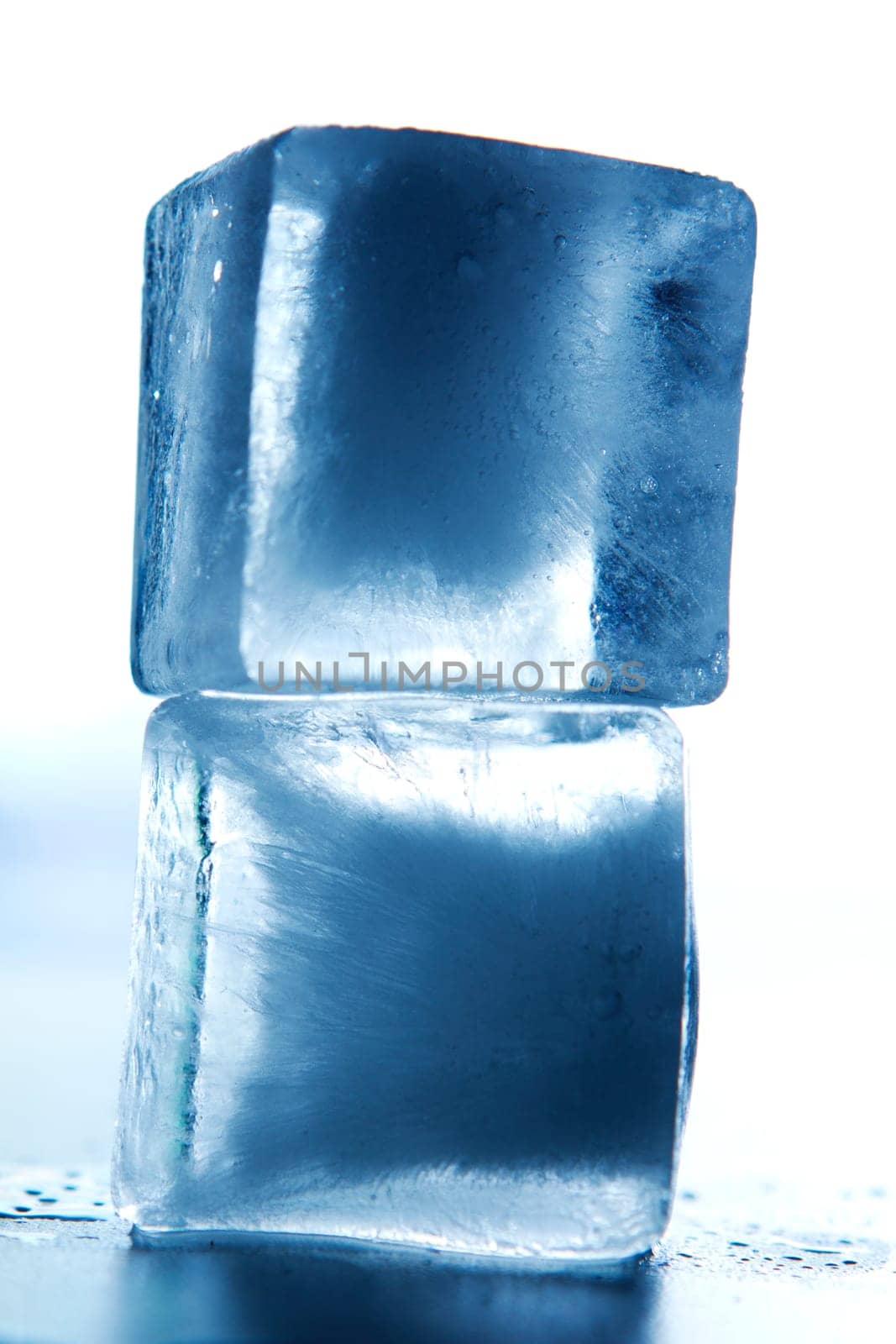 two ice cubes stacked with colored background