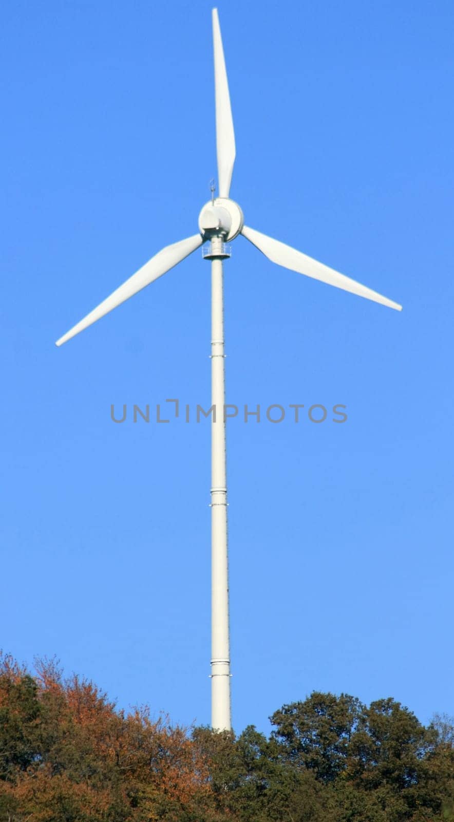 Wind turbine to generate electricity with blue sky in the background Wind turbine for power generation with blue sky in the background