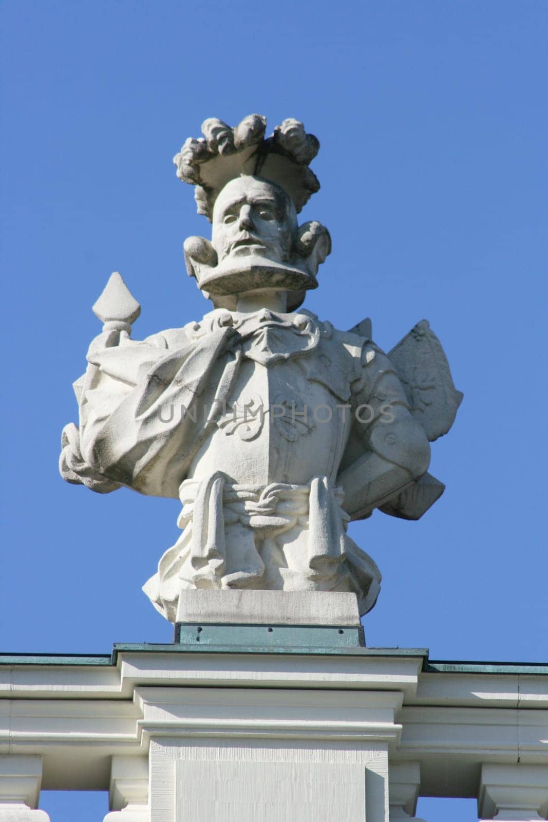 Imaginative statue made of grey stone,with blue sky in the background