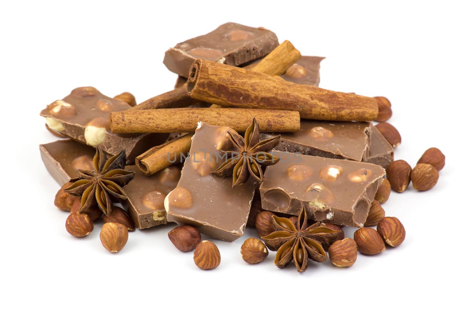 chocolate, spices and nuts on white background