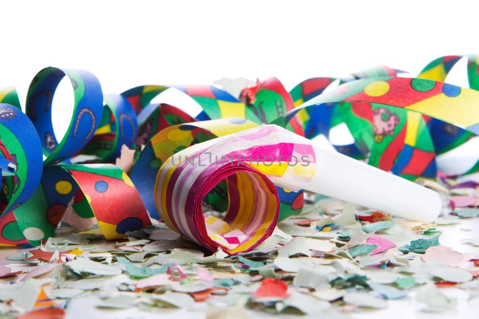 Streamers and confetti as party decoration for birthday with white background