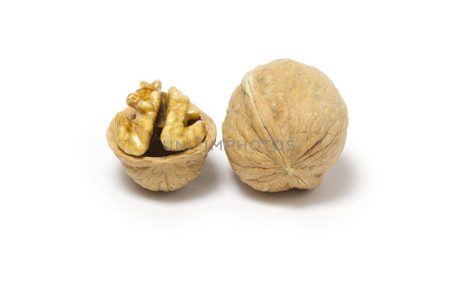 Close-up of two walnuts on white background