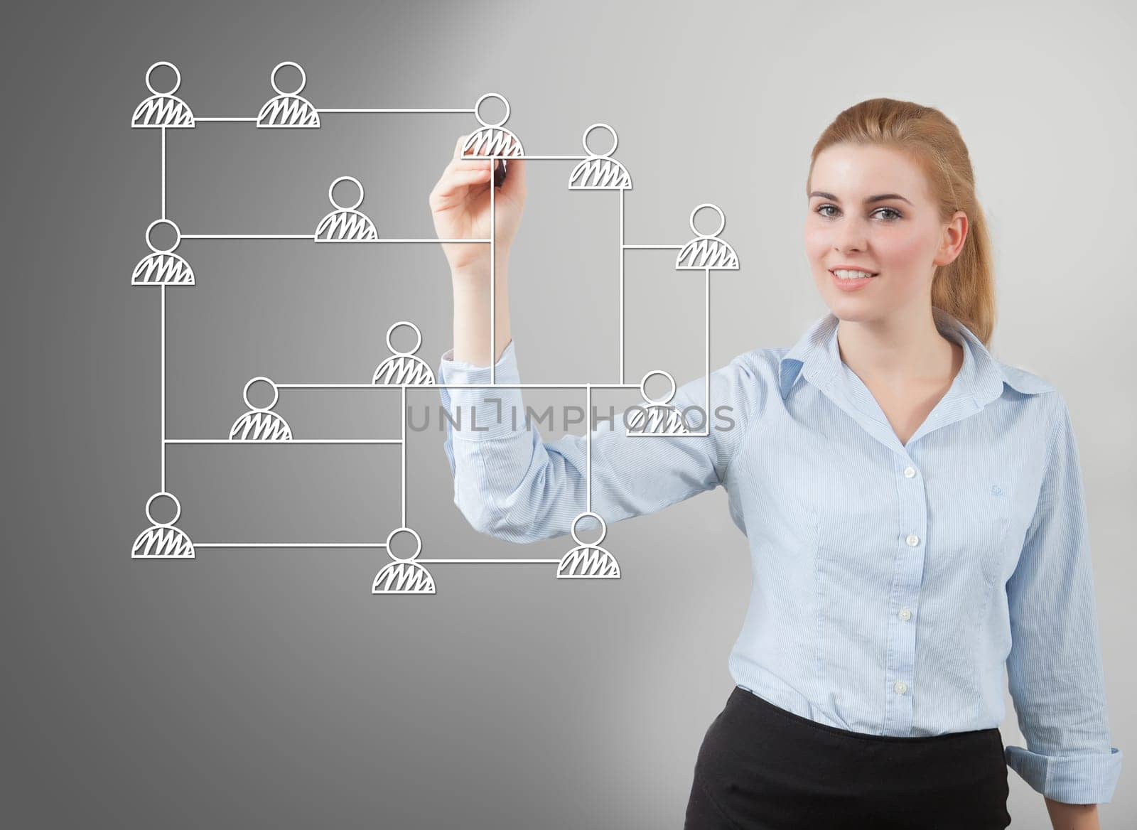 businesswoman drawing social network structure on glass