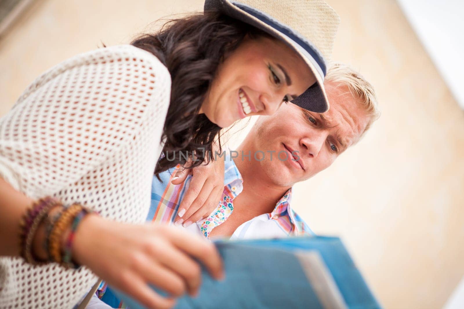 Young tourist couple in summer with map in the city travel tour
