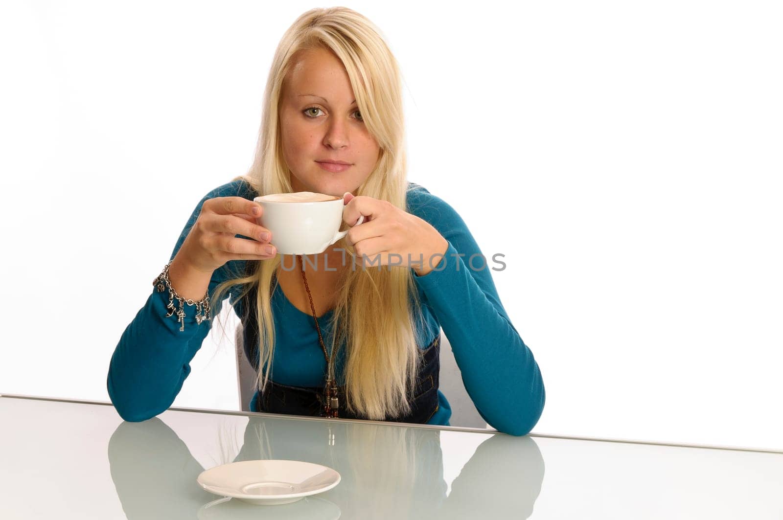 Young woman eating in front of a white background