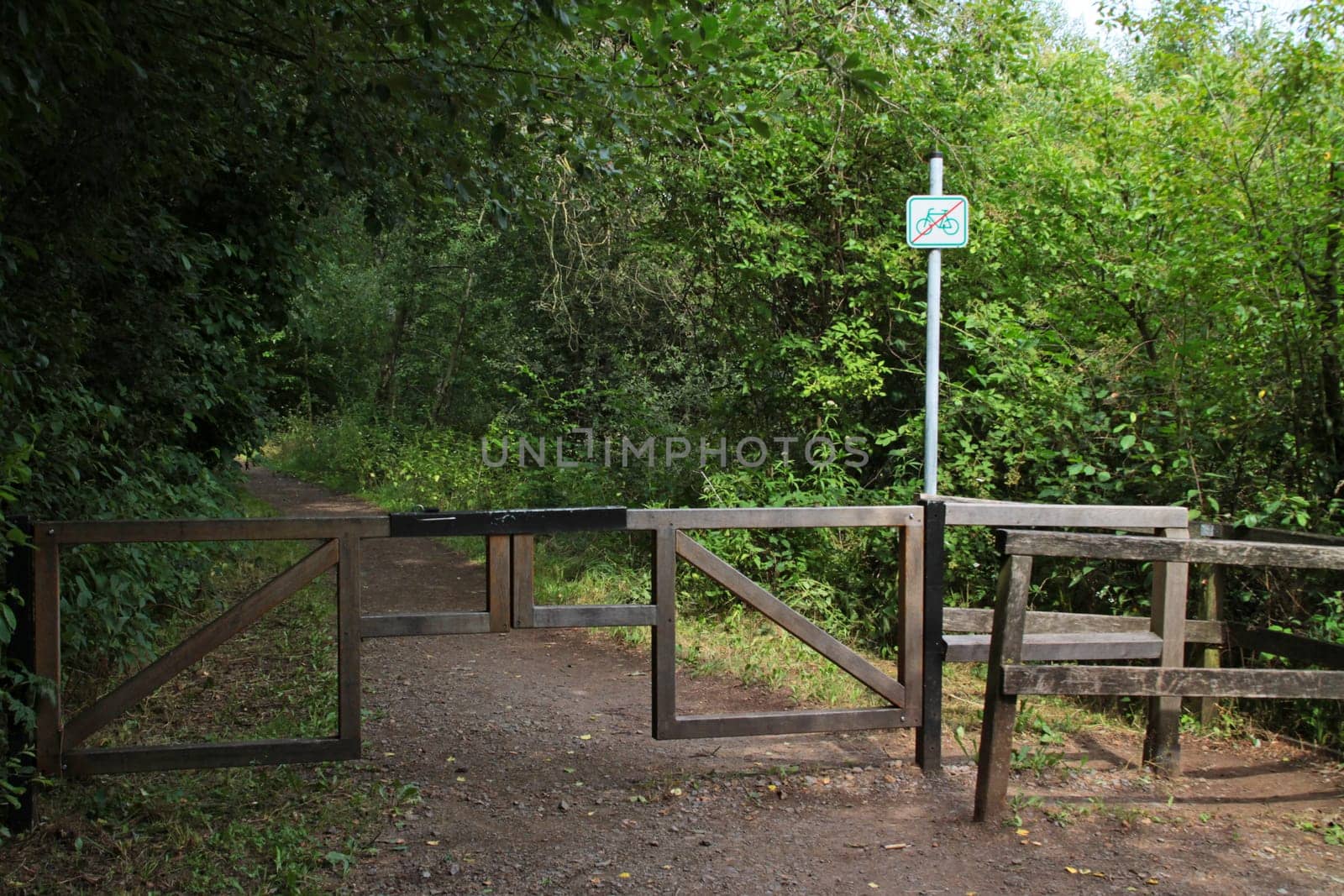 Forest path with vehicle barrier
