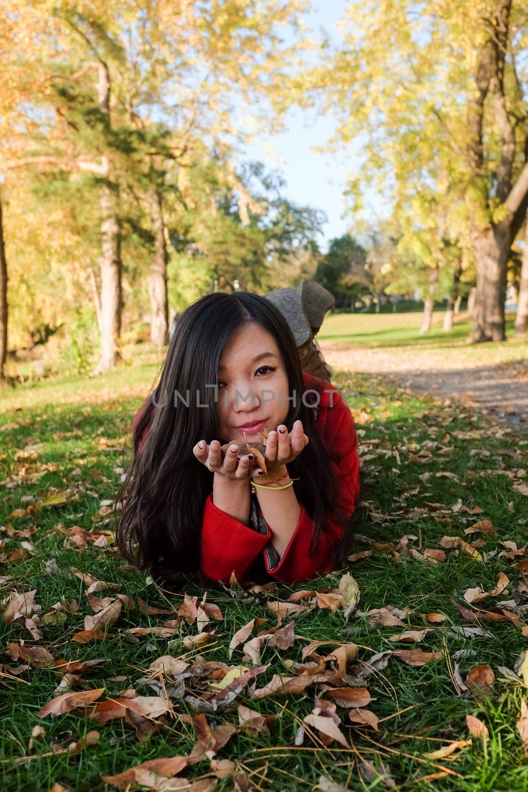 Woman laying on grass looking happy