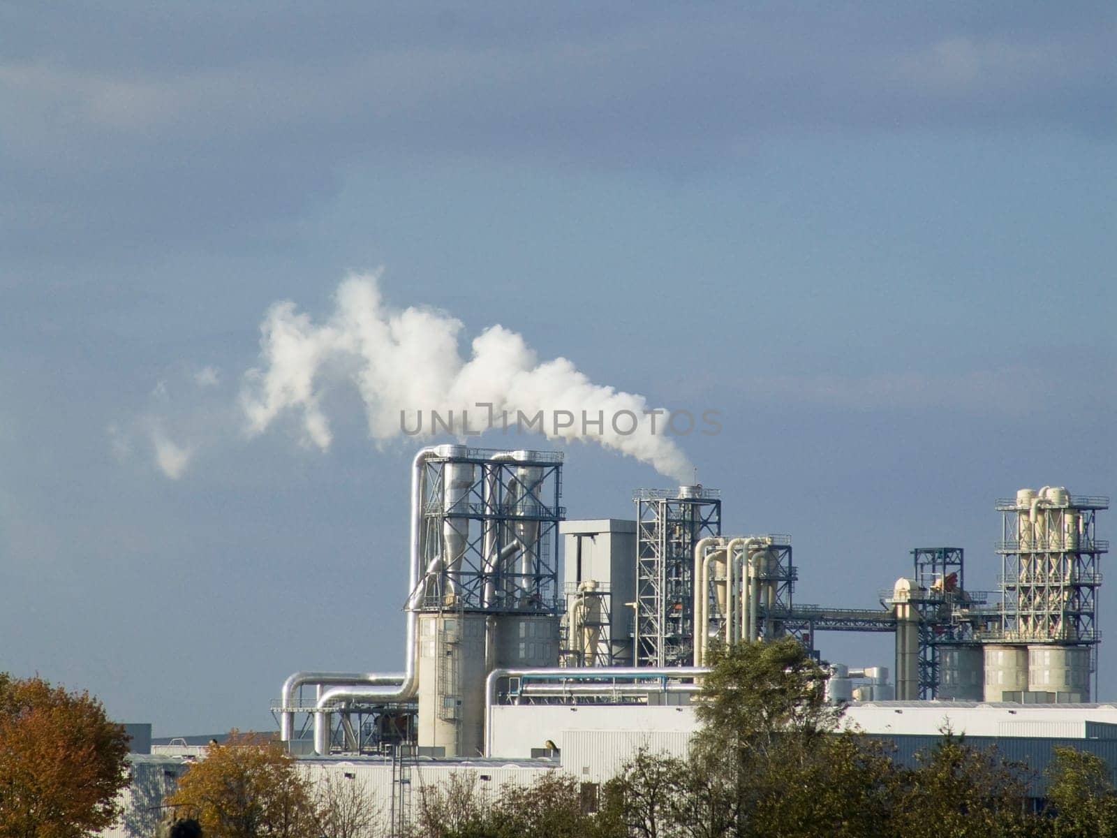 Ecological pollution by a white smoke from a factory pipe
