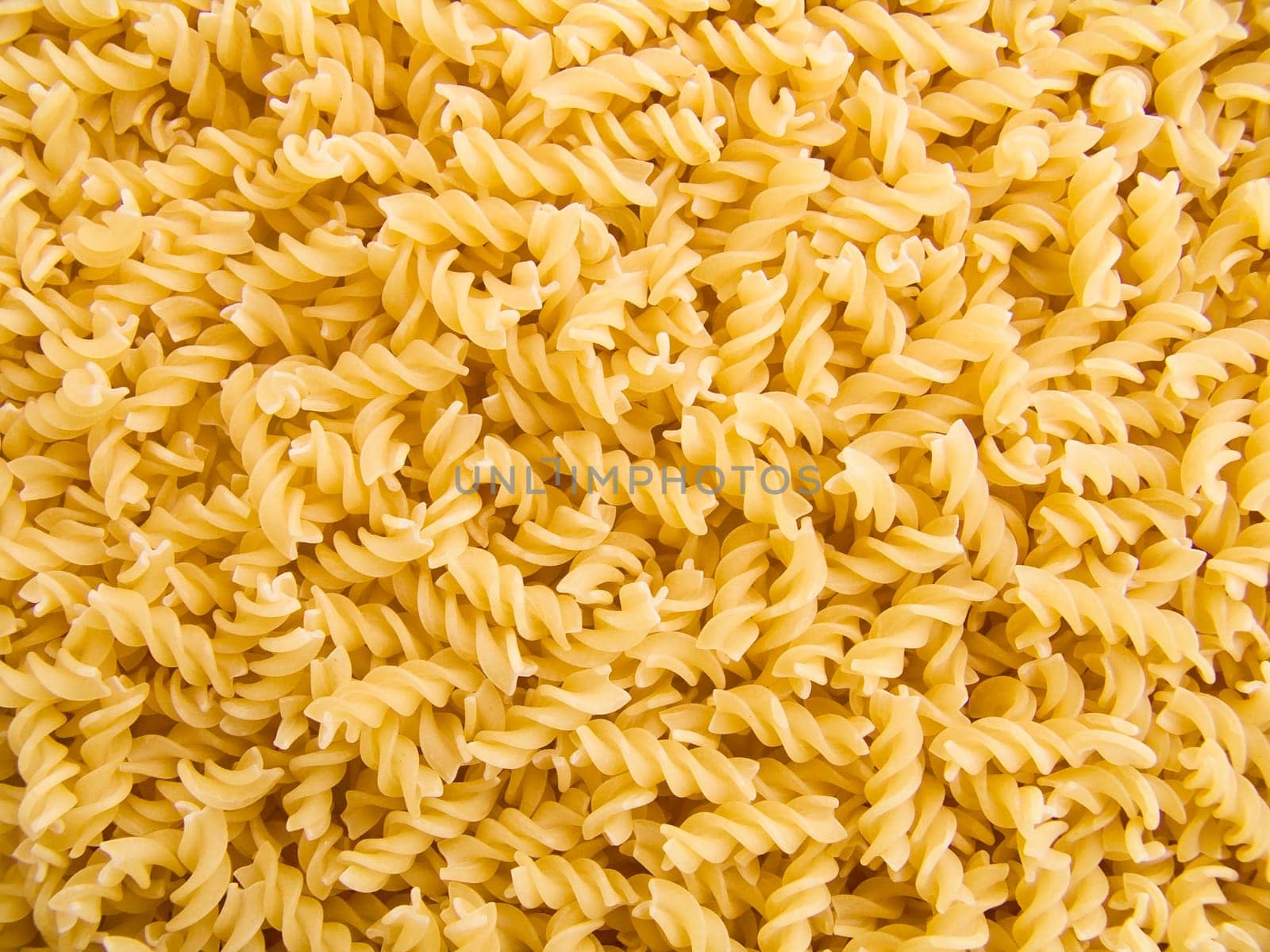food background a pile of beautiful spiral pasta