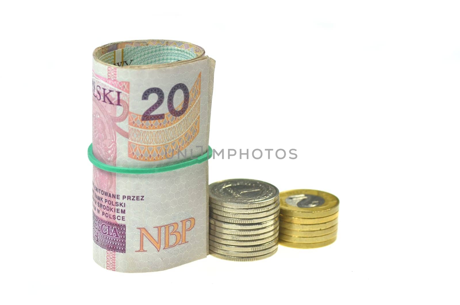 rolls of polish banknotes and coins isolated on white