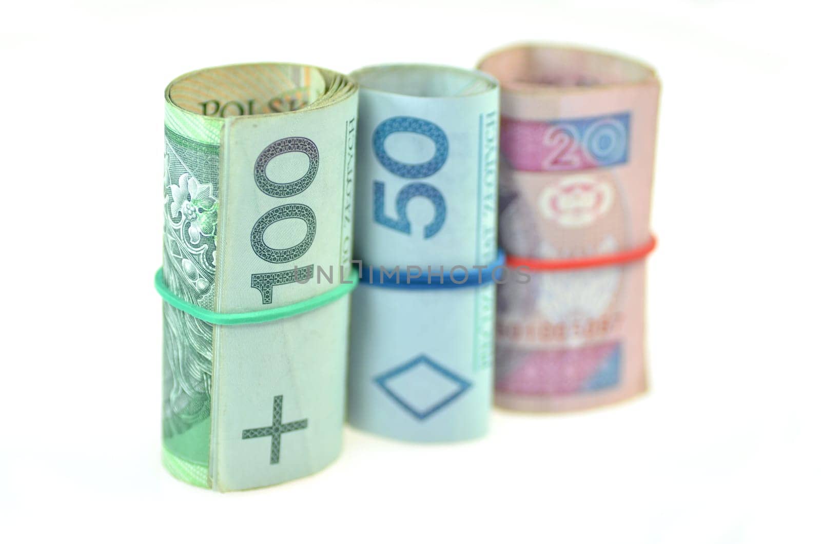 rolls of polish banknotes and coins isolated on white
