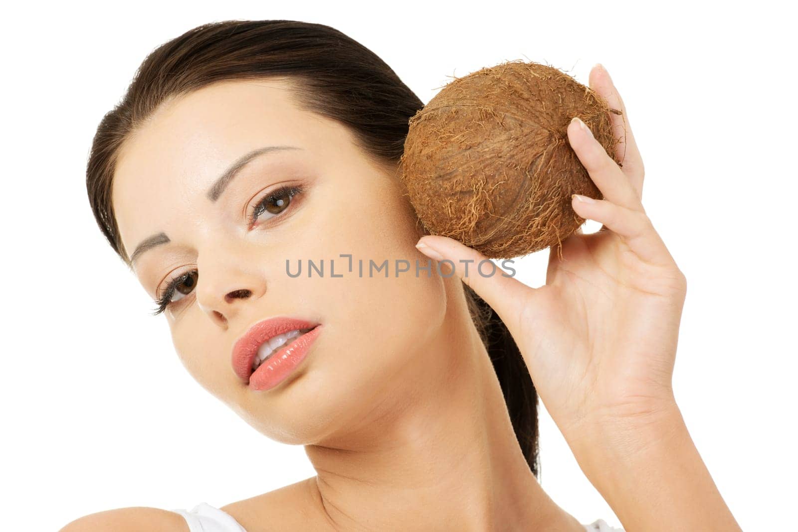 Beautiful woman with coconut in hands over white background