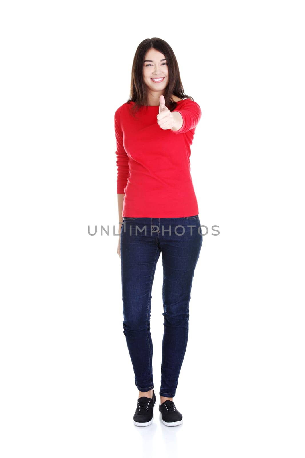 Beautiful young woman in casual clothes gesturing thumbs up.