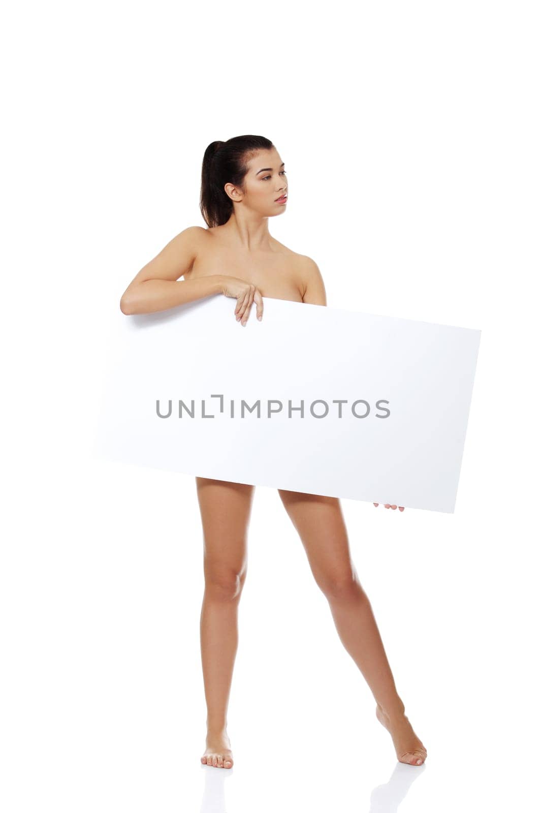 Sexy naked brunette holding empty board , isolated on white.