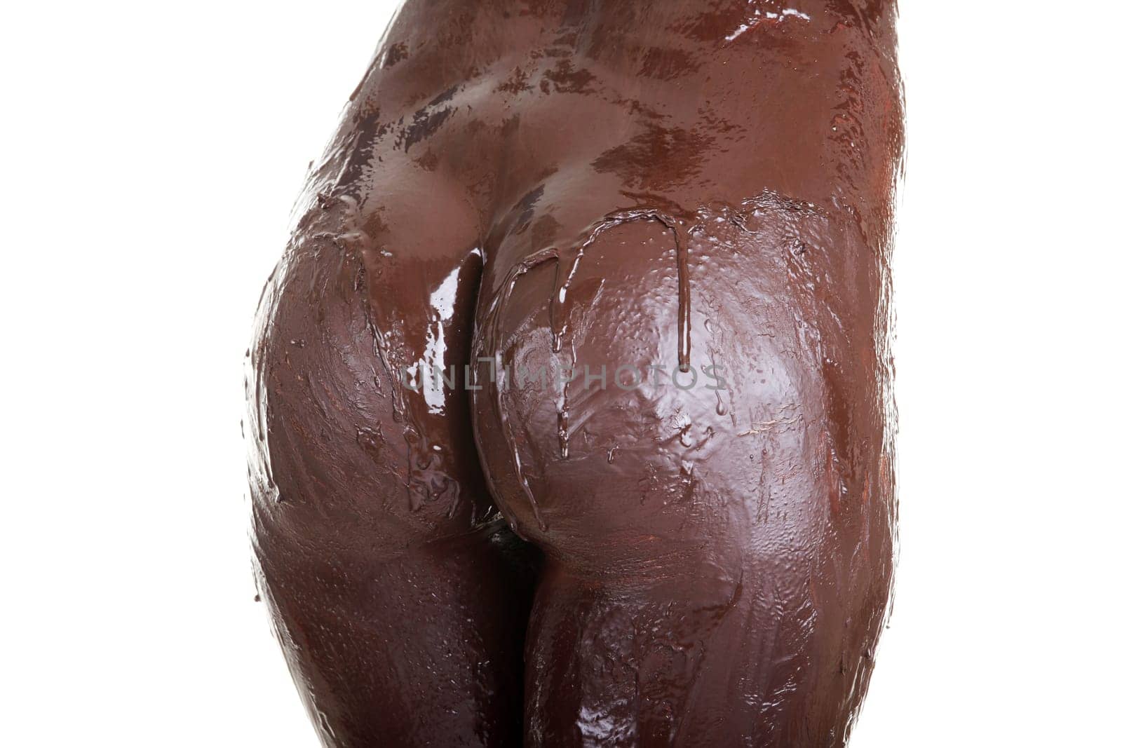 Naked female body covered with chocolate, isolated on white