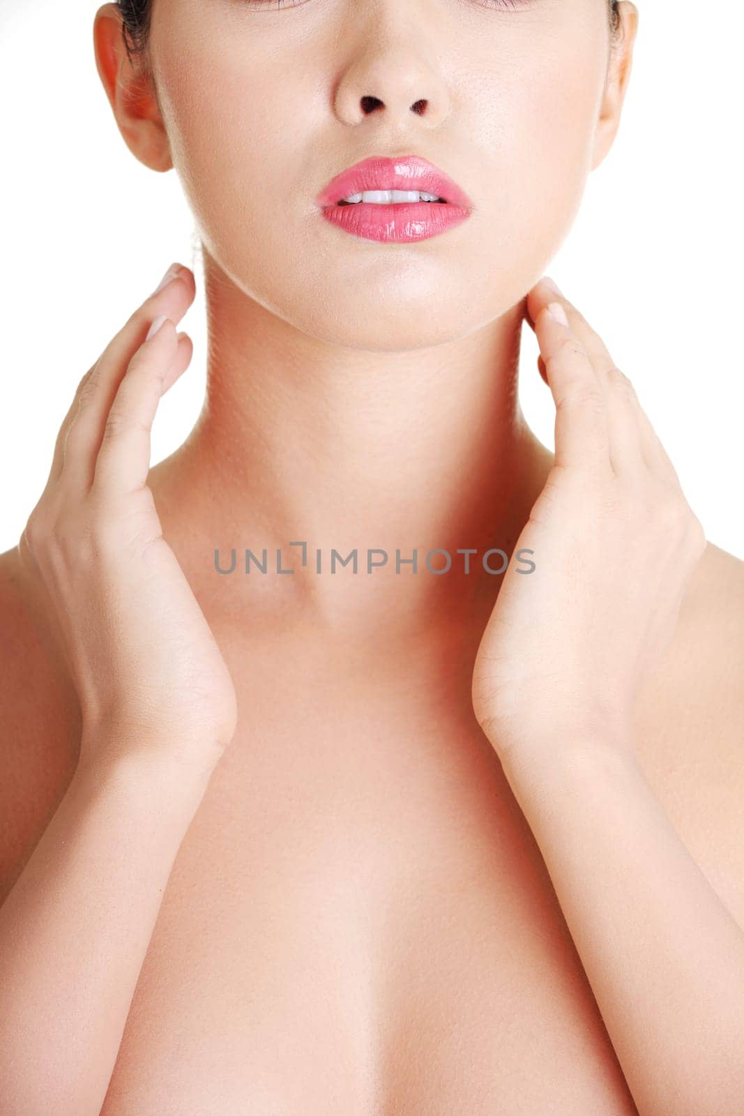 Beautiful sensual young woman touching her neck, isolated on white