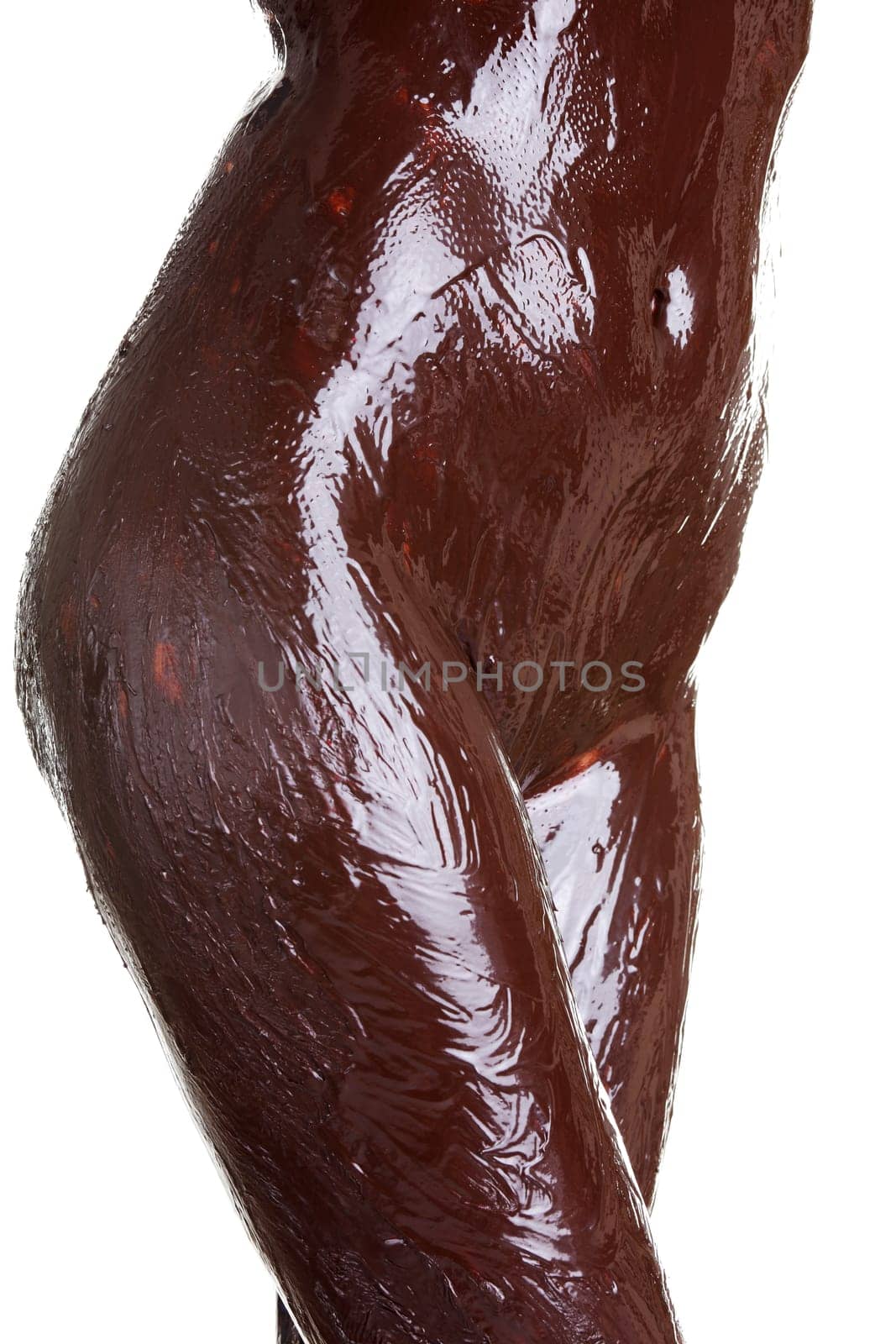 Naked female body covered with chocolate, isolated on white