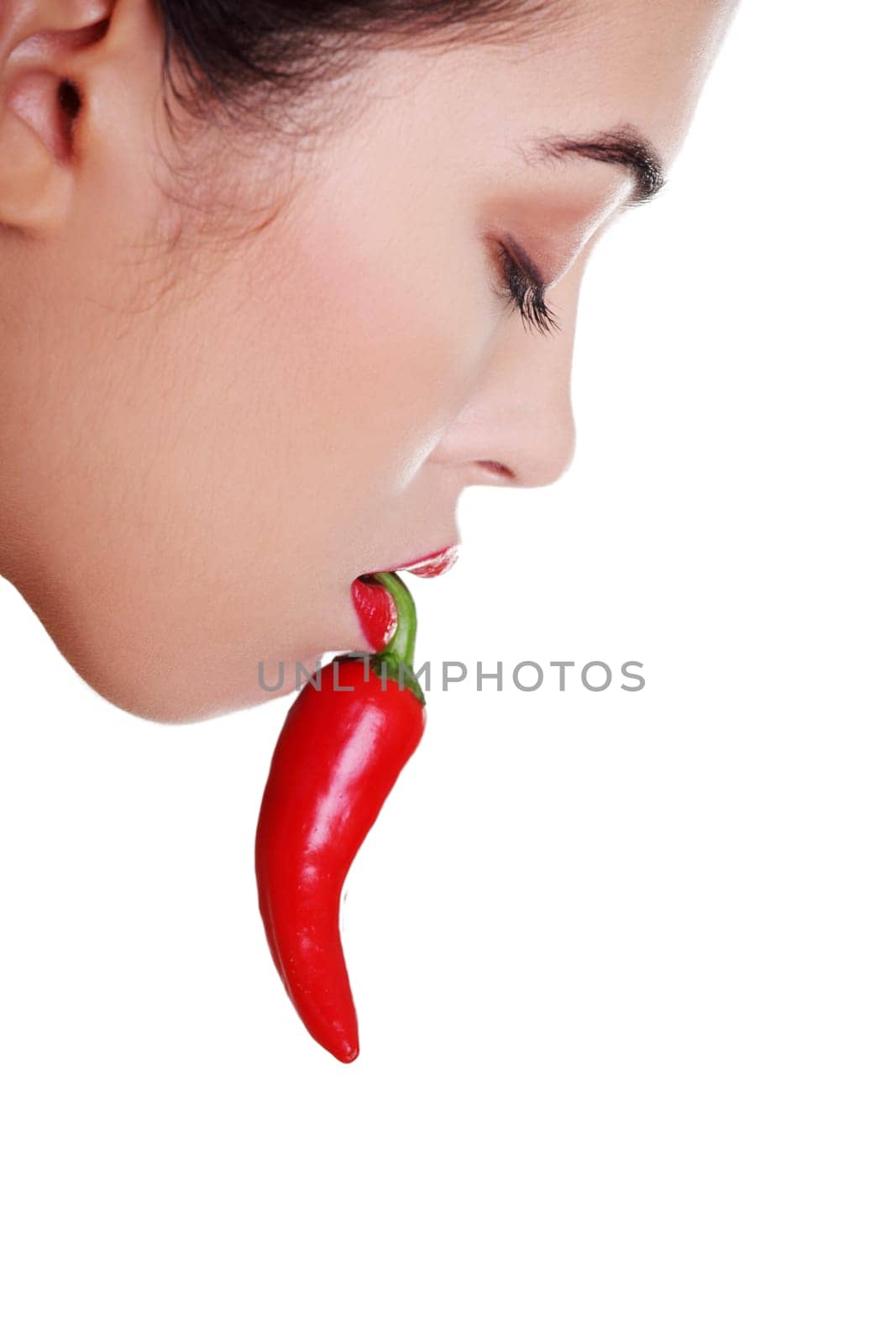 Beautiful woman lips with hot paprika, isolated on white