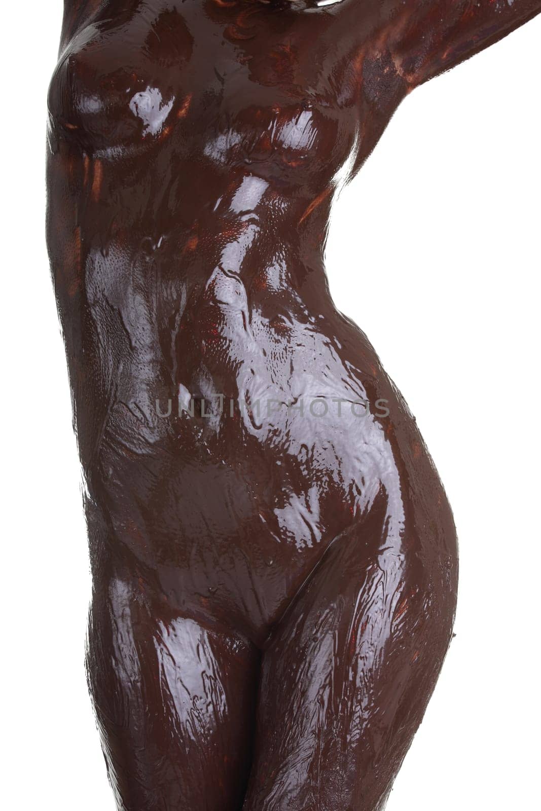 Naked female body covered with chocolate, isolated on white