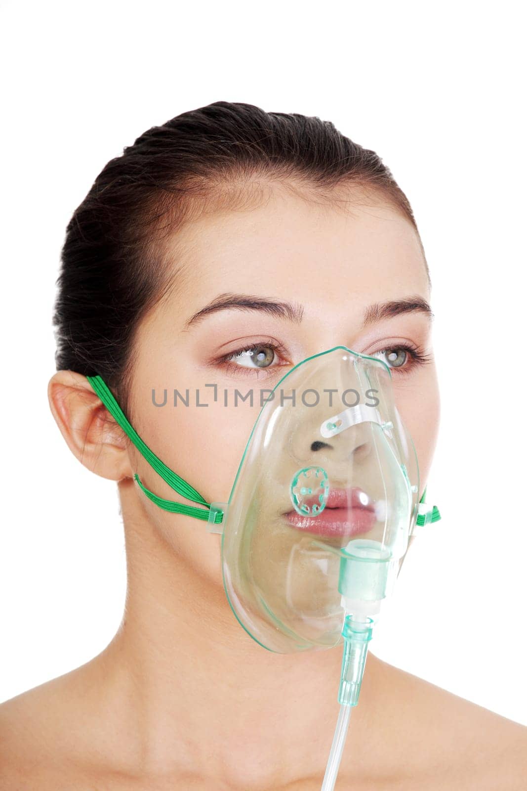 Diseased female patient wearing a oxygen mask against white background
