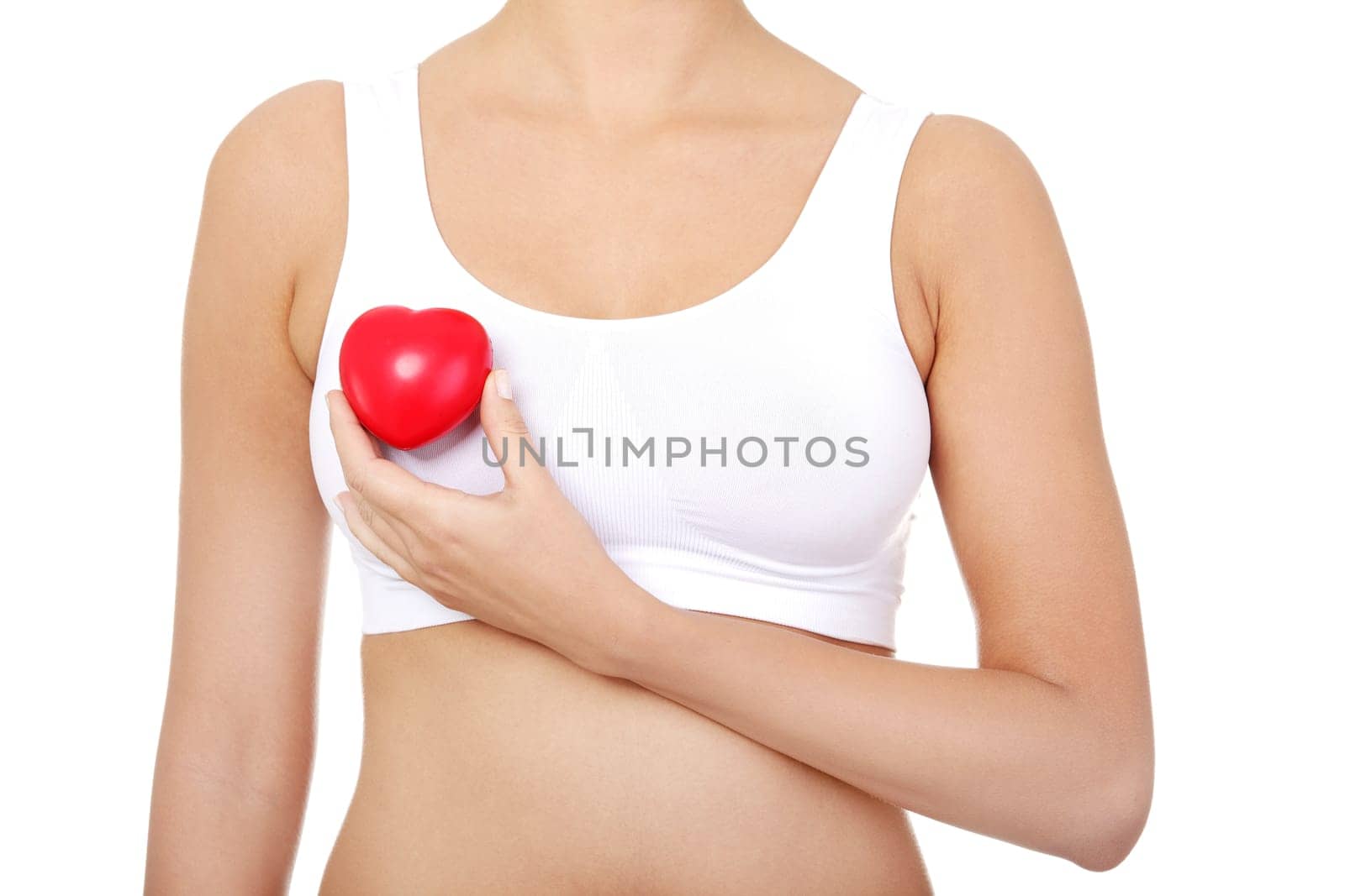 Fit female torso in white sport bra with red heart shaped toy