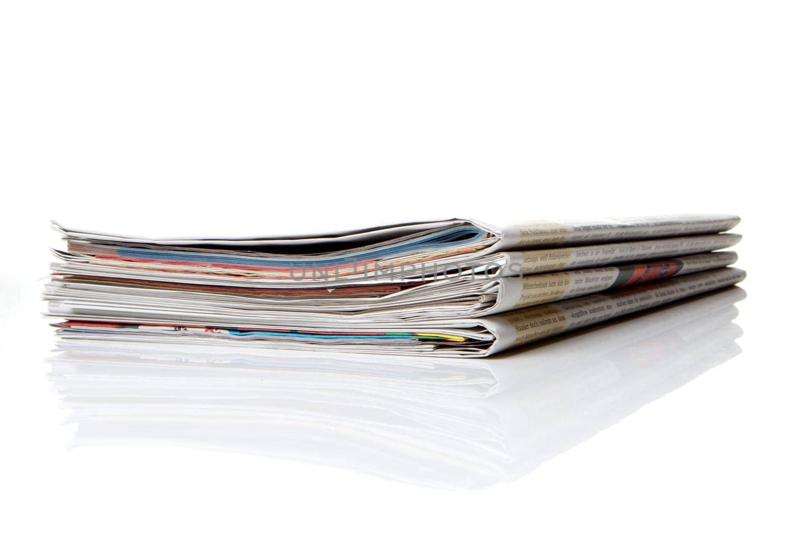 several newspapers stacked with white background