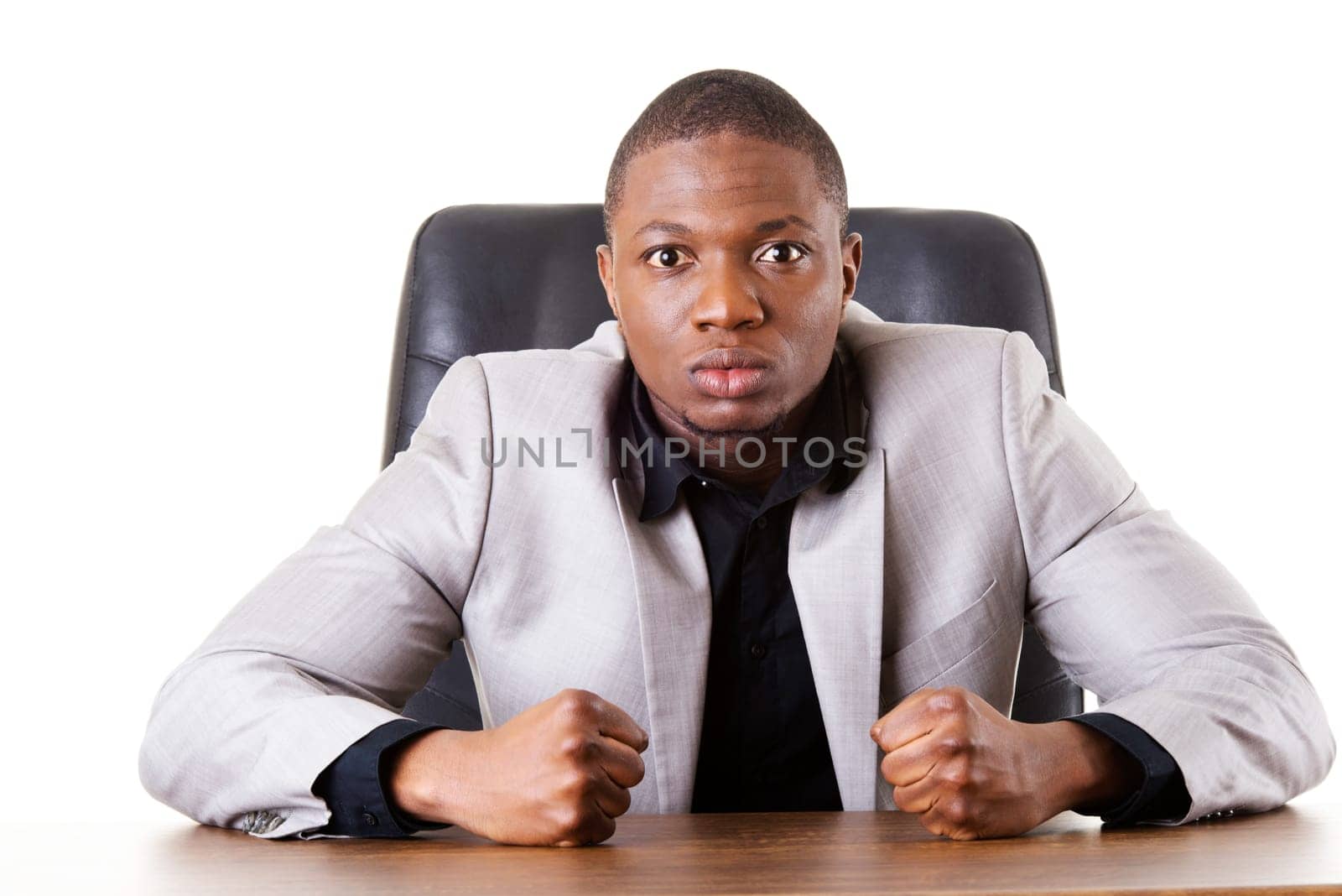 male businessman sitting in a chair,angry. madness. isolated on white.