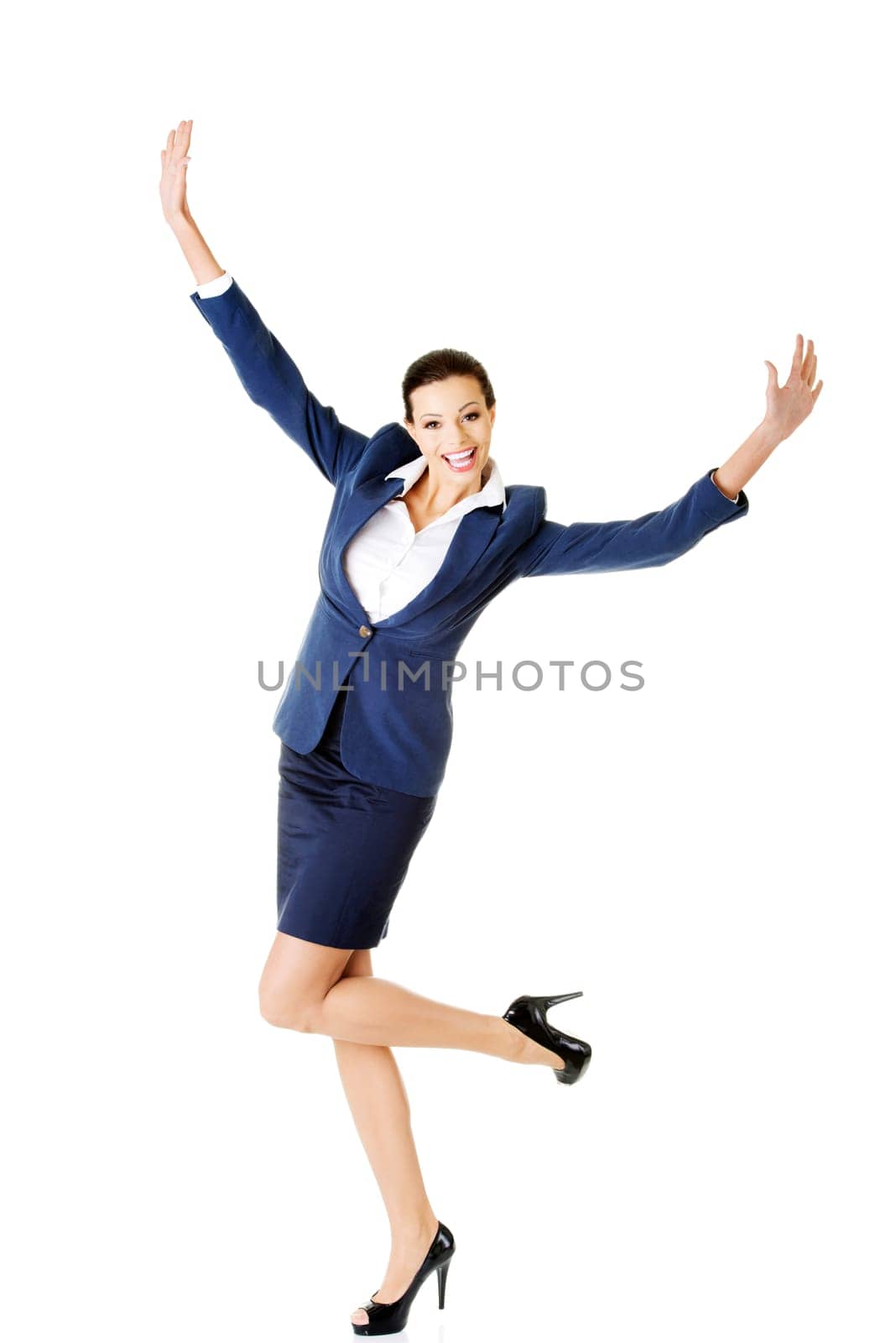 attractive businesswoman with hands up. cheerful. isolated on white.