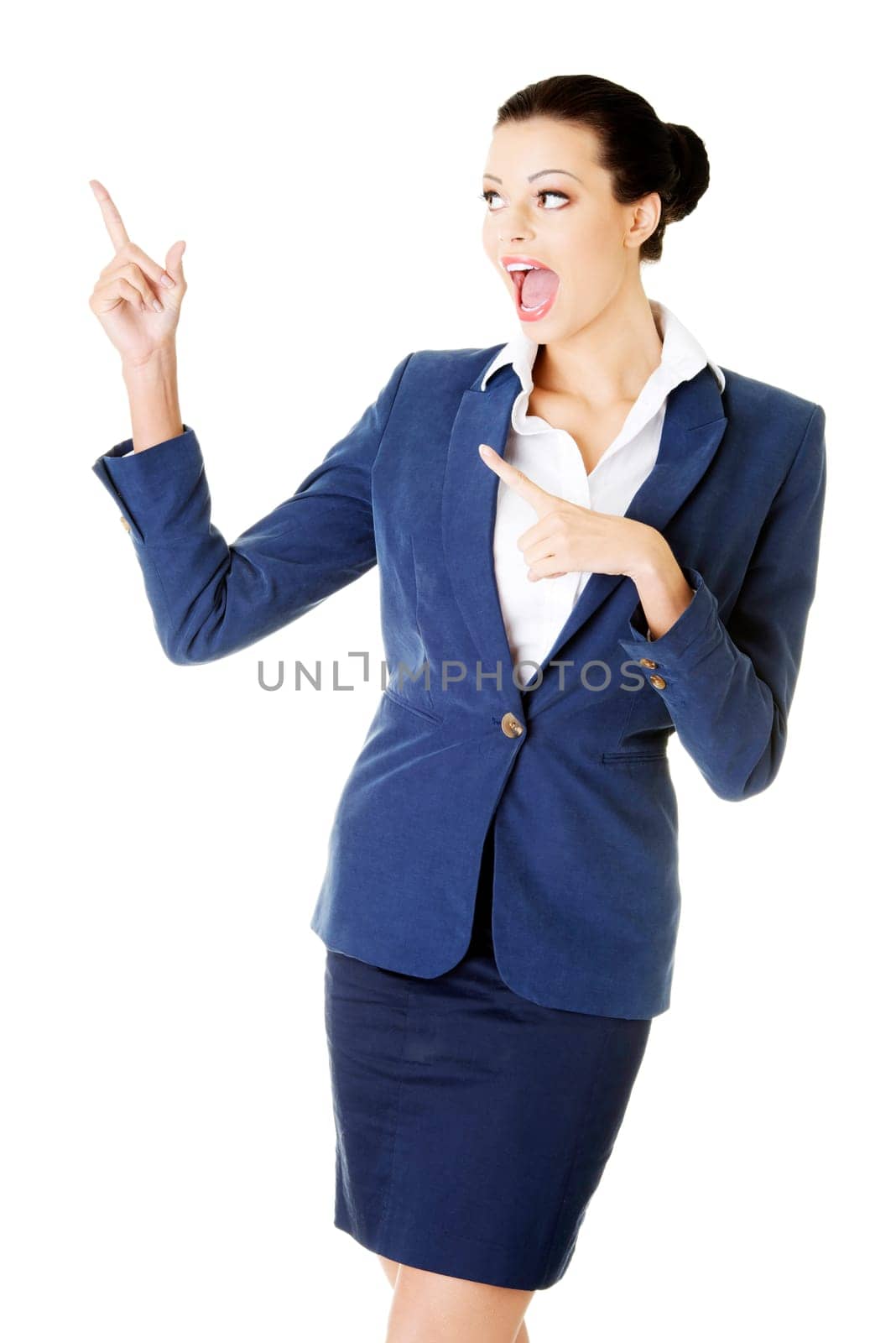 young female businesswoman pointing up. isolated on white.