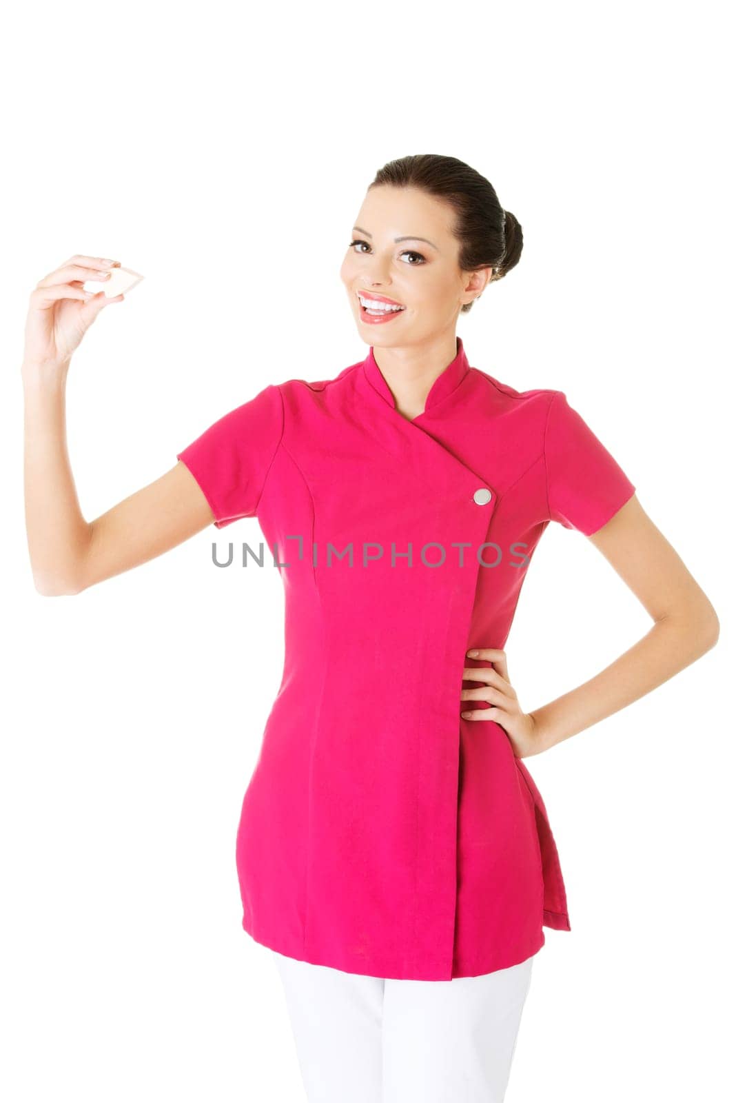 attractive woman holding a makeup sponge. isolated on white.