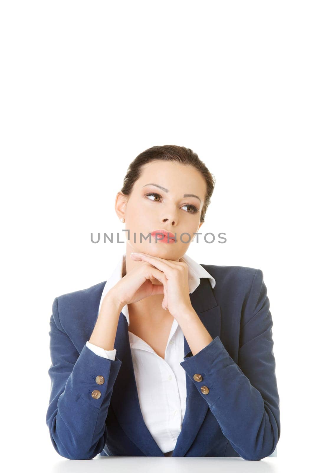 attractive business woman proping her head,sitting. isolated on white.