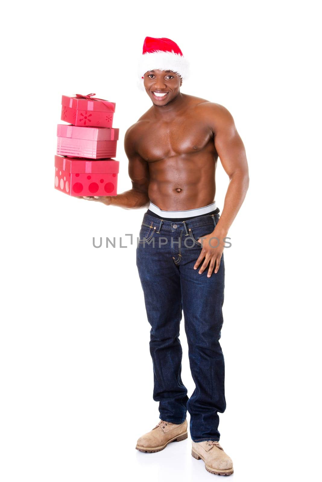 handsome nude man holding gifts and holding santa hat. isolated on white.