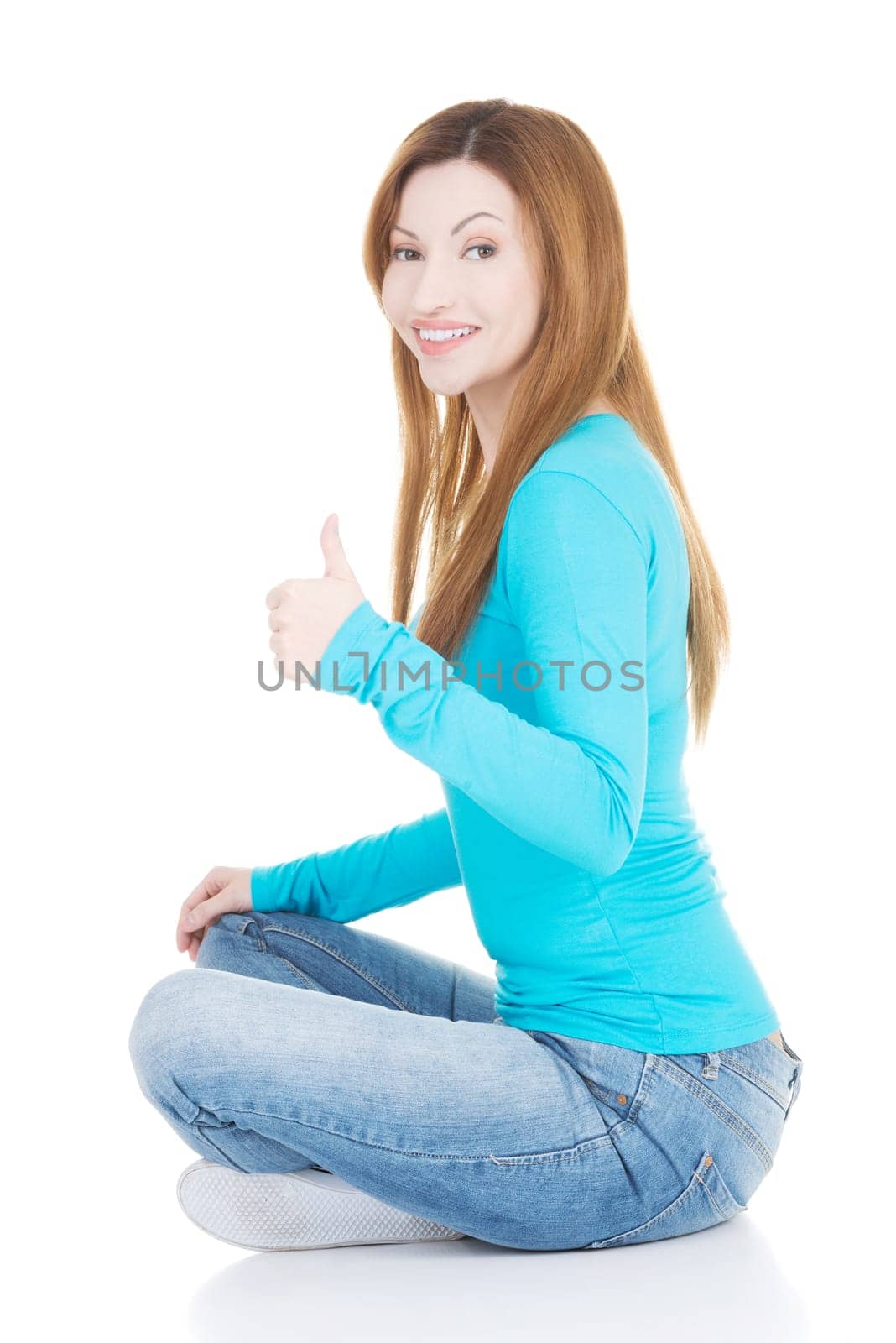 beautiful woman sitiing and showing ok. isolated on white.