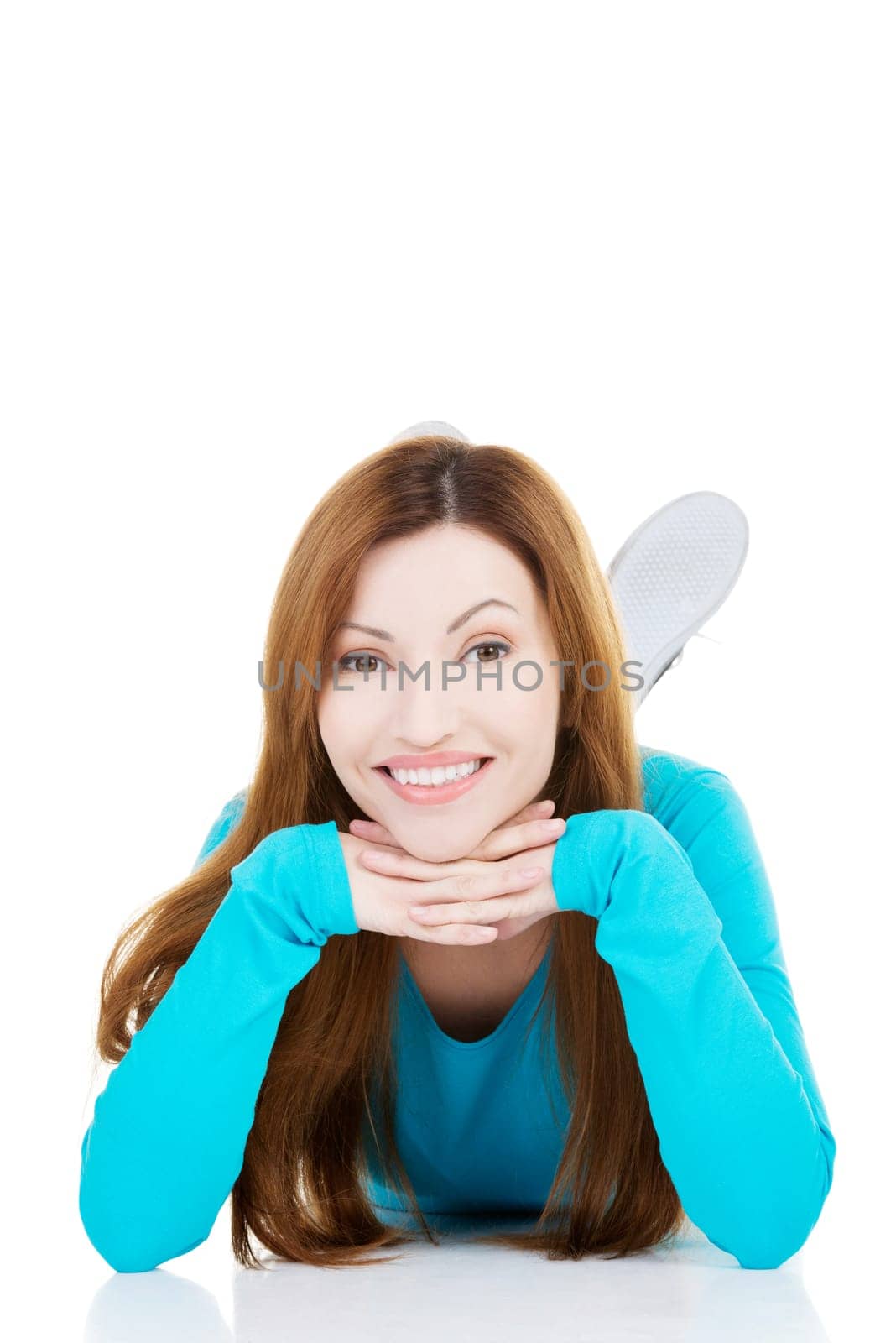 beautiful woman lying and proping her head. isolated on white.