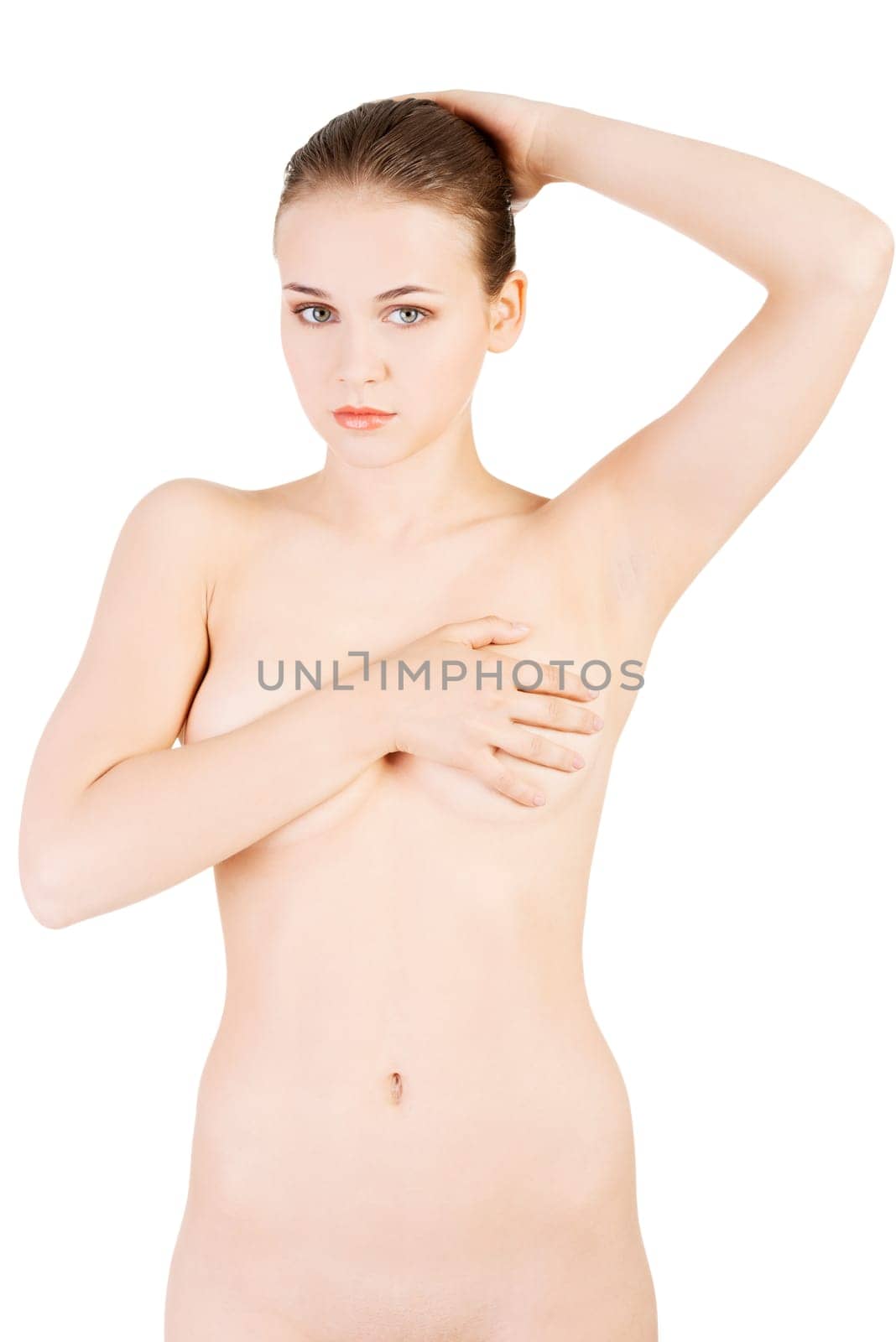 sexy naked woman holding her breasts and holding arm behind the neck. isolated on white.