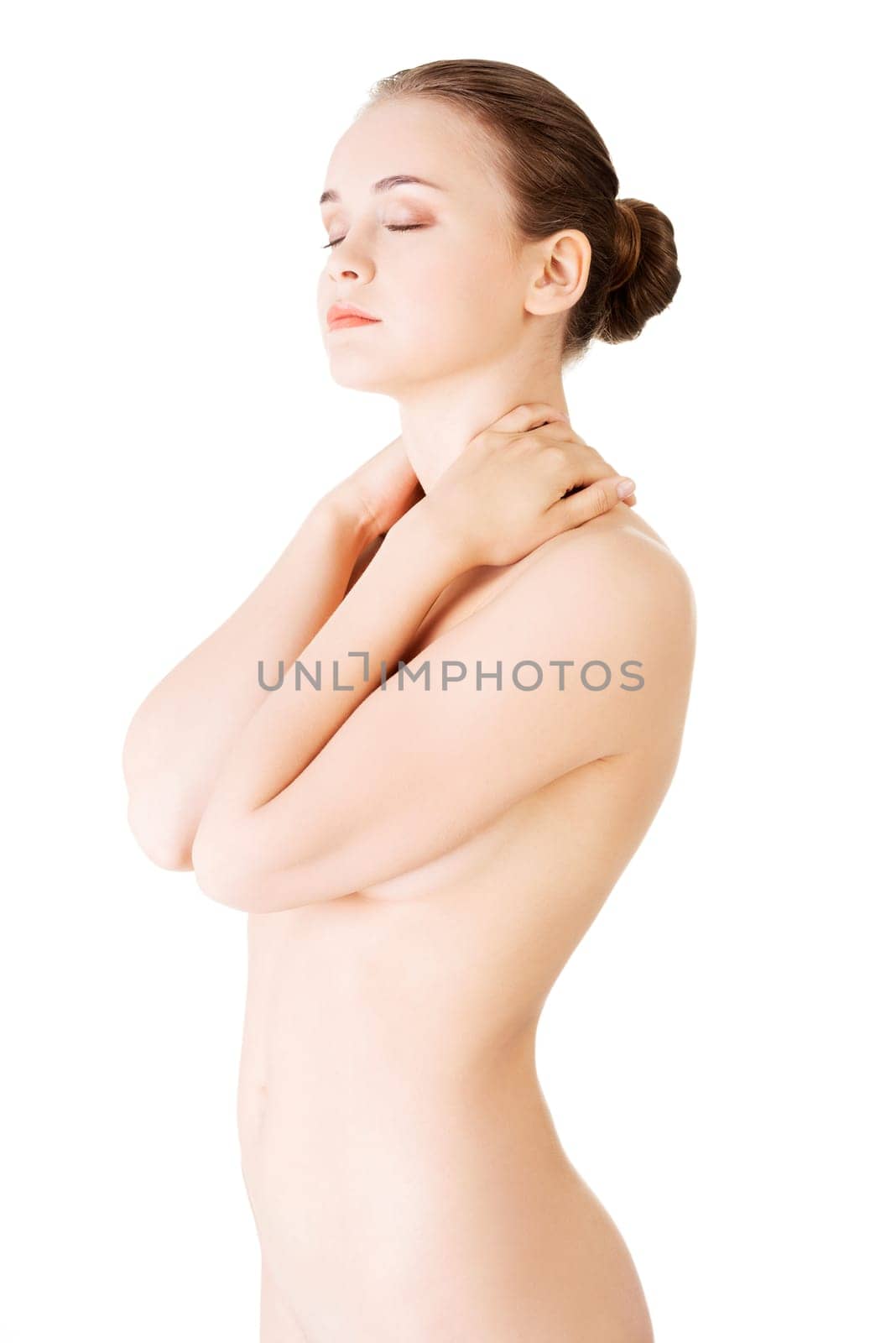 attractive naked woman touching her neck. front view. isolated on white.