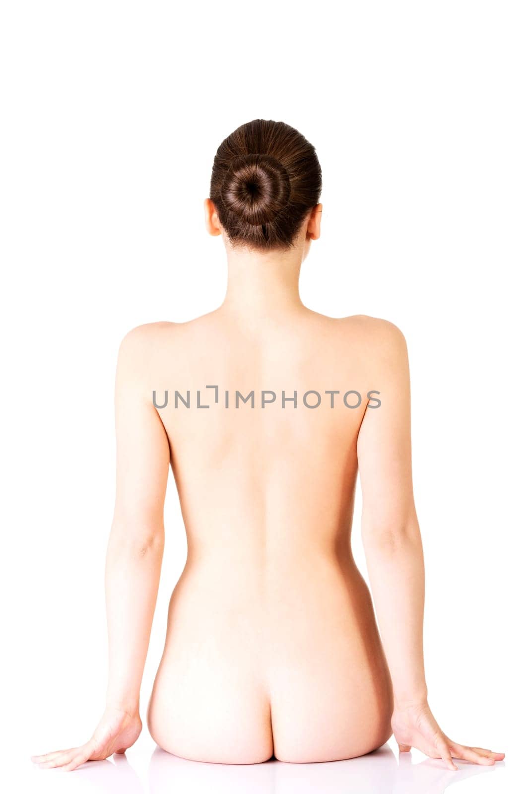 naked woman sitting. back view. isolated on white.