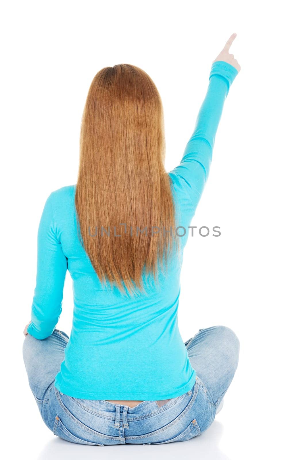 woman sitting and pointing up,back view. isolated on white.