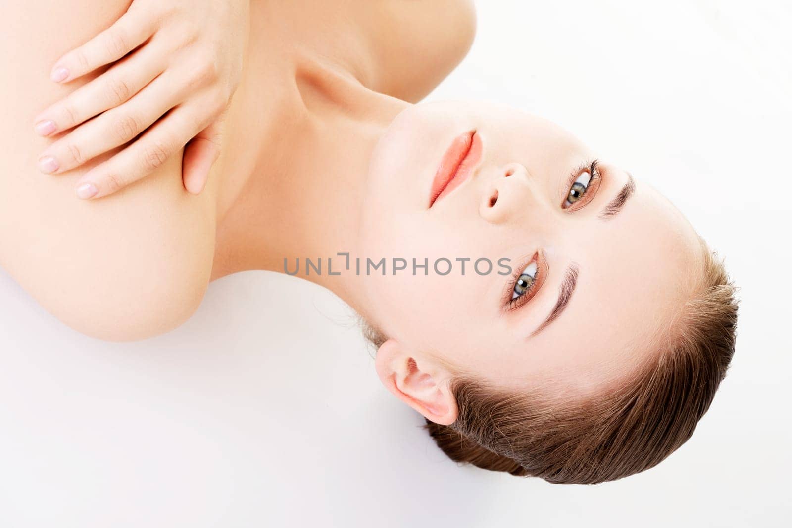 attractive woman lying on the floor and looking at camera. isolated on white.